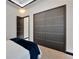 Bedroom featuring plush carpeting, modern trim, and large closet doors at 6542 Simone Shores Cir, Apollo Beach, FL 33572