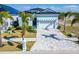 Charming, light-blue single-Gathering home featuring a well-manicured lawn, paver driveway, and a two-car garage at 6542 Simone Shores Cir, Apollo Beach, FL 33572