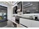 Sleek kitchen with modern appliances and contrasting black and white cabinetry under a decorative ceiling at 6542 Simone Shores Cir, Apollo Beach, FL 33572