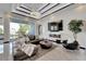 Bright living room with a decorative ceiling, fireplace, and a large window overlooking the beautiful outdoors at 6542 Simone Shores Cir, Apollo Beach, FL 33572