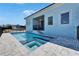 Backyard swimming pool and spa with decorative tiling, surrounded by a paved patio at 6542 Simone Shores Cir, Apollo Beach, FL 33572