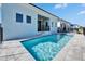 Backyard swimming pool with patio, an exterior view of the house, and a safety fence at 6542 Simone Shores Cir, Apollo Beach, FL 33572