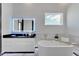 Elegant bathroom with a freestanding soaking tub and modern fixtures at 6542 Simone Shores Cir, Apollo Beach, FL 33572