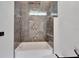 Modern bathroom with a bathtub and marble tile shower surround at 6542 Simone Shores Cir, Apollo Beach, FL 33572