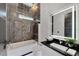 Modern bathroom with a bathtub, shower, and marble tile at 6542 Simone Shores Cir, Apollo Beach, FL 33572