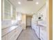 Modern kitchen with white cabinets, gray countertops, and tile flooring at 912 Oxford Park Dr, Sun City Center, FL 33573
