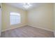 Simple bedroom with light walls, wood-look floors, and a window with blinds at 912 Oxford Park Dr, Sun City Center, FL 33573
