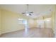 Vaulted ceiling living room with neutral walls and laminate flooring at 912 Oxford Park Dr, Sun City Center, FL 33573