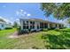 Rear view of single story home with sunroom and spacious backyard at 912 Oxford Park Dr, Sun City Center, FL 33573
