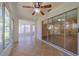 Sunroom with tiled floor, ceiling fan and sliding glass doors at 912 Oxford Park Dr, Sun City Center, FL 33573