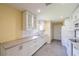White kitchen with gray countertops and stainless steel appliances at 912 Oxford Park Dr, Sun City Center, FL 33573