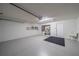 Garage with painted floor, utility sink, and storage shelving at 912 Oxford Park Dr, Sun City Center, FL 33573
