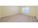 Bright bedroom with light walls, wood-look floors, and a window with blinds at 912 Oxford Park Dr, Sun City Center, FL 33573