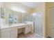 Bathroom boasts double vanity, large mirror and a shower at 912 Oxford Park Dr, Sun City Center, FL 33573