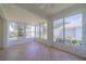 Bright sunroom with tiled floor, large windows and a ceiling fan at 912 Oxford Park Dr, Sun City Center, FL 33573