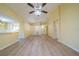 Bright and airy living room with laminate flooring and a view to the kitchen at 912 Oxford Park Dr, Sun City Center, FL 33573