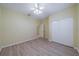 Spacious bedroom with light walls, wood-look floors, and a large closet at 912 Oxford Park Dr, Sun City Center, FL 33573
