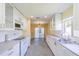 Bright kitchen with white cabinets, stainless steel appliances, and a view to the backyard at 912 Oxford Park Dr, Sun City Center, FL 33573