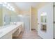 Bright bathroom with double sinks, shower, and ample storage at 912 Oxford Park Dr, Sun City Center, FL 33573