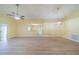 Bright living room with vaulted ceilings, ceiling fan, and laminate wood flooring at 912 Oxford Park Dr, Sun City Center, FL 33573