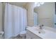 Clean bathroom with white vanity, toilet, and shower/tub combo at 912 Oxford Park Dr, Sun City Center, FL 33573