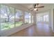 Sunroom with tiled floor, ceiling fan, and view of backyard at 912 Oxford Park Dr, Sun City Center, FL 33573