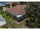 Aerial view showcasing home's layout, roof, and surrounding landscape at 912 Oxford Park Dr, Sun City Center, FL 33573