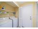 Laundry room with washer, dryer, and shelving for storage at 912 Oxford Park Dr, Sun City Center, FL 33573