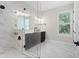 This bathroom boasts double sinks, marble shower, and a window with natural light at 4606 W Fig St # 4, Tampa, FL 33609