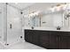 This bathroom features double sinks, marble shower, and a modern vanity at 4606 W Fig St # 4, Tampa, FL 33609