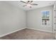 This bedroom boasts neutral walls, carpet, ceiling fan, and a window with natural light at 4606 W Fig St # 4, Tampa, FL 33609