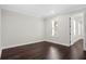 A well-lit bedroom with crown molding, wood floors, and a view of the hallway at 4606 W Fig St # 4, Tampa, FL 33609