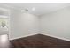 An empty room with crown molding, wood floors, and a view to another room at 4606 W Fig St # 4, Tampa, FL 33609