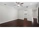 This bedroom features hardwood floors, neutral walls, ceiling fan, and a walk-in closet at 4606 W Fig St # 4, Tampa, FL 33609
