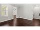 An empty room with dark hardwood floors and a window with shutter blinds at 4606 W Fig St # 4, Tampa, FL 33609