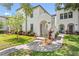 Charming two-story home featuring a stucco facade, arched entryway, and lush landscaping at 4606 W Fig St # 4, Tampa, FL 33609