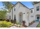 Charming two-story home featuring a stucco facade, arched entryway, and lush landscaping at 4606 W Fig St # 4, Tampa, FL 33609