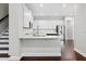 Modern kitchen with white cabinets, stainless steel appliances, and a breakfast bar with counter seating at 4606 W Fig St # 4, Tampa, FL 33609