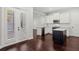Bright kitchen with white cabinets, stainless steel appliances and hardware, contrasting island and hardwood flooring at 4606 W Fig St # 4, Tampa, FL 33609