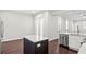 Modern kitchen with stainless steel appliances, breakfast bar with counter seating and adjacent shuttered door at 4606 W Fig St # 4, Tampa, FL 33609
