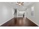 Bright living area featuring hardwood floors, staircase, and seamless transition to the modern, well-lit kitchen at 4606 W Fig St # 4, Tampa, FL 33609