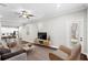 Inviting living room featuring hardwood floors, a stylish entertainment center, and a view into the modern kitchen at 4606 W Fig St # 4, Tampa, FL 33609