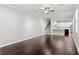Bright living area featuring hardwood floors, staircase, and seamless transition to the modern, well-lit kitchen at 4606 W Fig St # 4, Tampa, FL 33609
