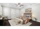 A modern main bedroom suite with a ceiling fan, king size bed, and a bench at 4606 W Fig St # 4, Tampa, FL 33609