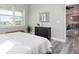 Spacious bedroom with large windows, dresser, and view into the kitchen at 3431 Sheephead Dr, Hernando Beach, FL 34607