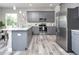 Modern kitchen with gray cabinets, stainless steel appliances, and granite countertops at 3431 Sheephead Dr, Hernando Beach, FL 34607