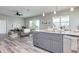 Modern kitchen with island, stainless steel appliances, and views to living room at 3431 Sheephead Dr, Hernando Beach, FL 34607