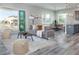 Open concept living room with gray sofa and access to kitchen and balcony at 3431 Sheephead Dr, Hernando Beach, FL 34607