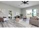 Bright living room with open floor plan, sliding glass doors, and hardwood floors at 3431 Sheephead Dr, Hernando Beach, FL 34607