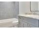 Bathroom with gray vanity, granite countertop, and bathtub at 3431 Sheephead Dr, Hernando Beach, FL 34607